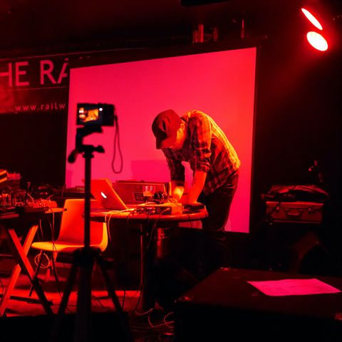 My former self, bathed in red light, hunched over a laptop